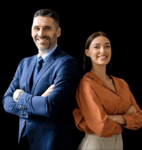 Professional man in a suit and woman in business attire standing confidently with arms crossed.